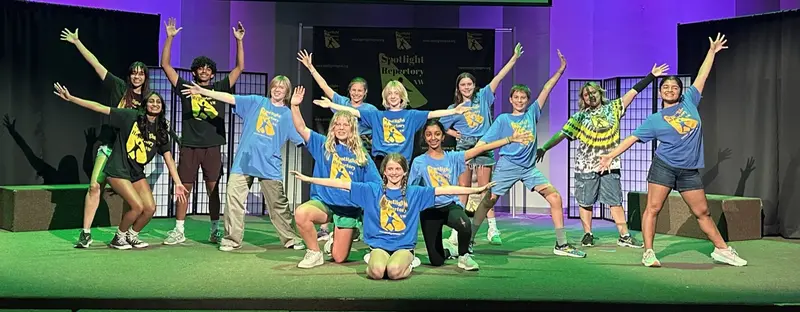 Summer camp students gathered on stage